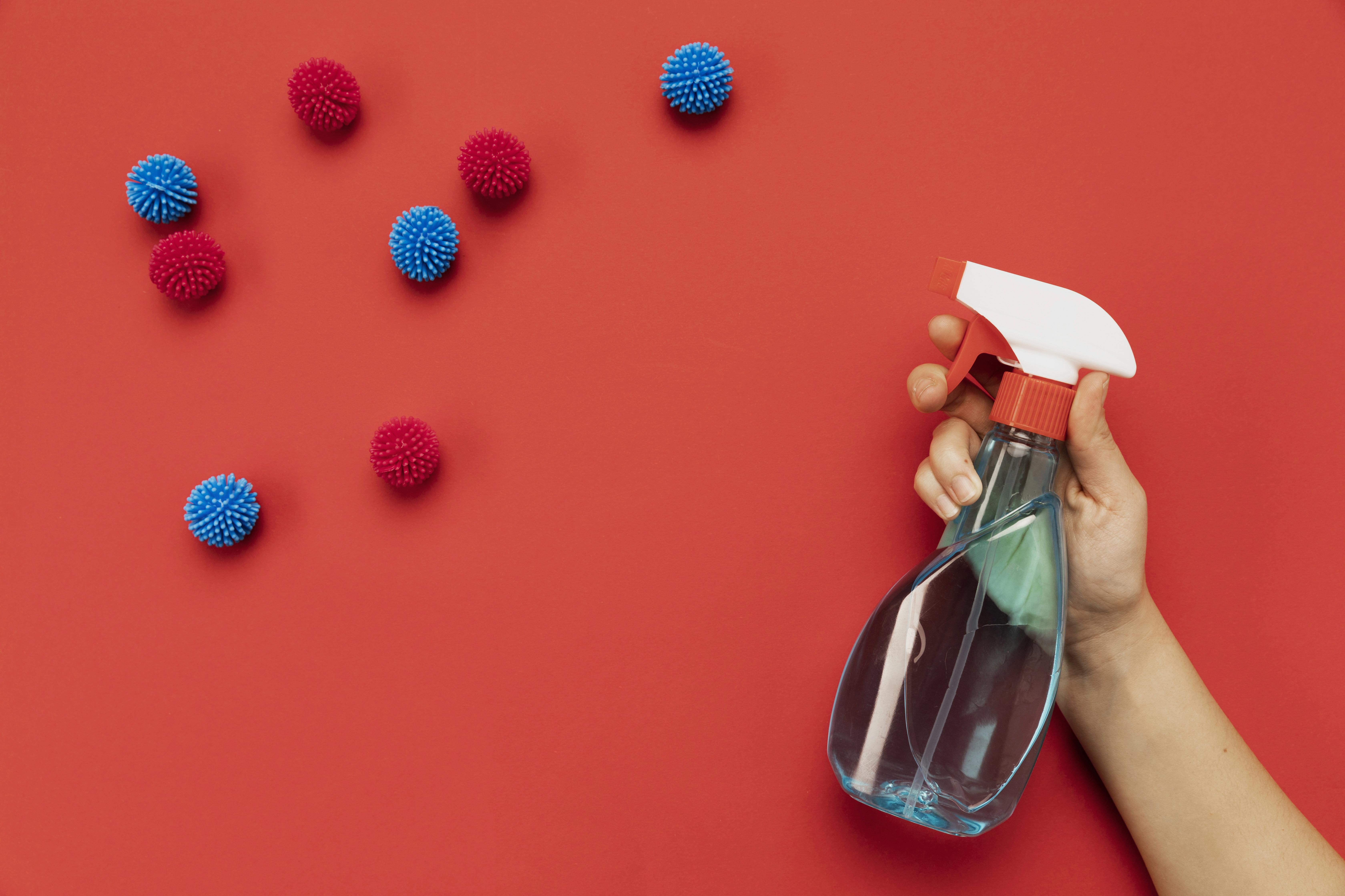 top-view-hand-holding-disinfectant-with-decorative-balls top-view-hand-holding-disinfectant-with-decorative-balls